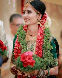 bride wearing green saree and makeup done by Persona